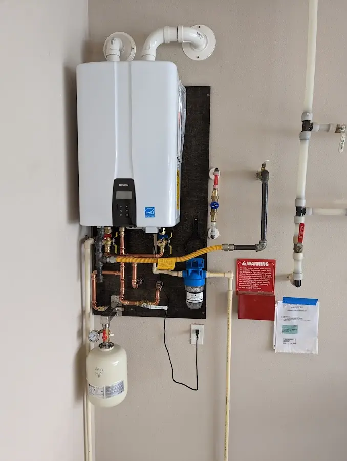 Professional plumber installing copper piping in a Miramar Beach home